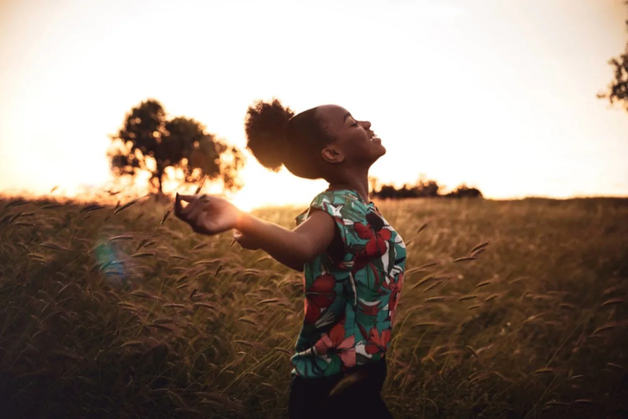 woman enjoying freedom in a sunset